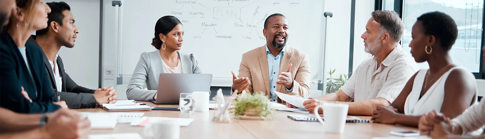 A group of employees sitting at a roundtable.