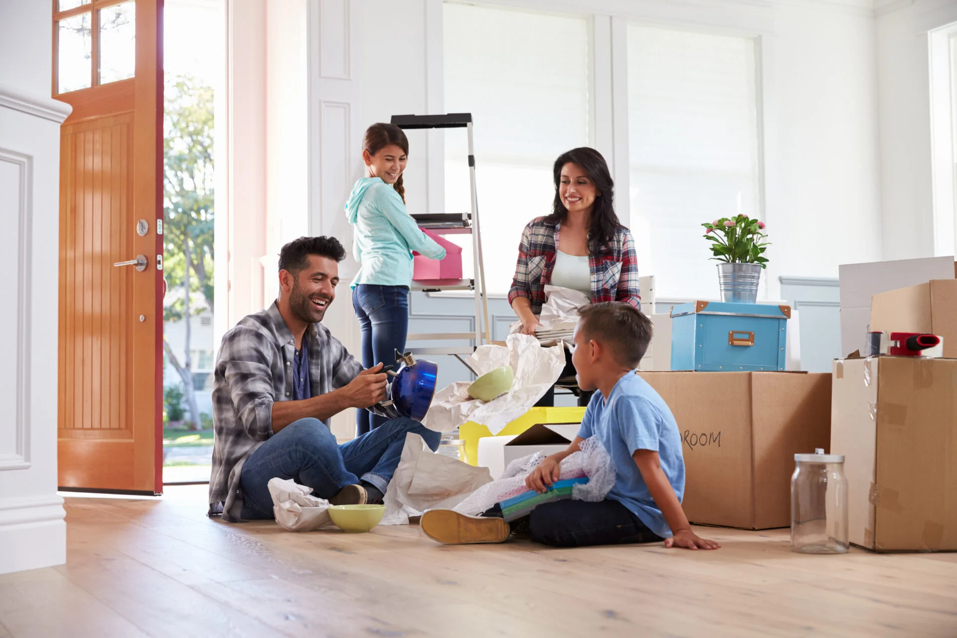 Happy family surrounded by moving boxes