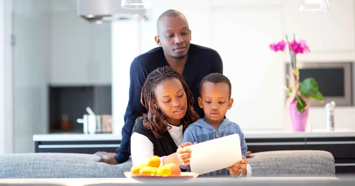 Family of three looking at tablet